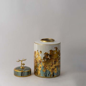 Elegant ceramic jar with teal lid and golden deer top featuring textured gold tree artwork for luxury home decor.