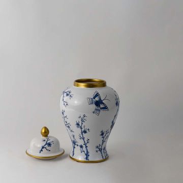 Blue and white ceramic jar with butterfly and floral design and golden lid accent for elegant home decor styling.