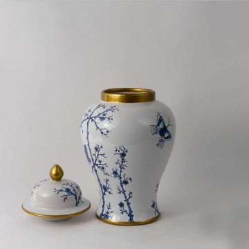 White ceramic jar with blue floral butterfly design and golden lid accent ideal for elegant home decor styling.