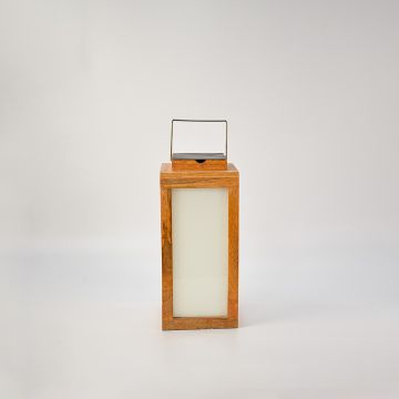 Wood lantern glowing on a white background showing its frosted glass panel illumination and premium wood craftsmanship — a modern decorative lighting piece.