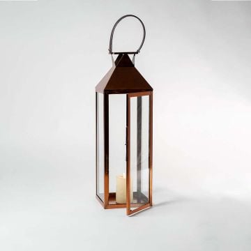 Brown metal lantern with clear glass panels displayed on white background for stylish modern home decor accent.