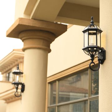 Elegant lantern wall light illuminating the outdoor entrance for stylish exterior home lighting.
