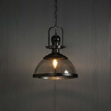 Vintage black metal pendant light with clear glass Turned off against black background.