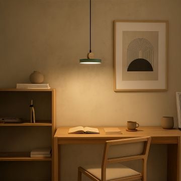 Green wood and metal pendant light styled above study desk with books chair and wall art for modern home lighting.