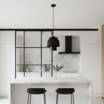 Elegant black pendant light illuminating a modern kitchen island.