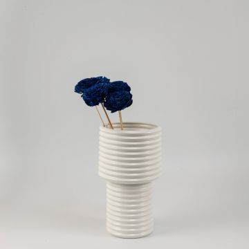 Blue sola flower sticks arranged in a modern ceramic vase with decorative artificial flowers for home and office decor.