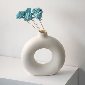 Aqua sola flower sticks in a modern round ceramic vase with artificial decorative flowers for elegant home and office decor.