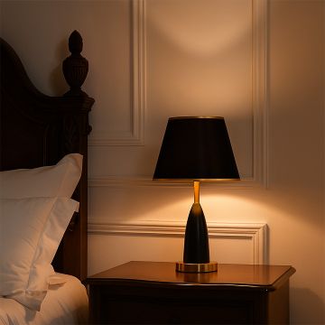 Black and gold table lamp with modern design styled on bedside table in luxury bedroom interior decor table lamp.