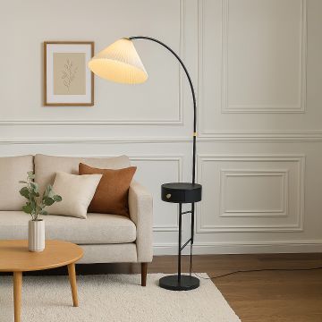 Modern floor lamp with metal arc body and shade placed beside sofa adding ambient lighting to contemporary living room decor.