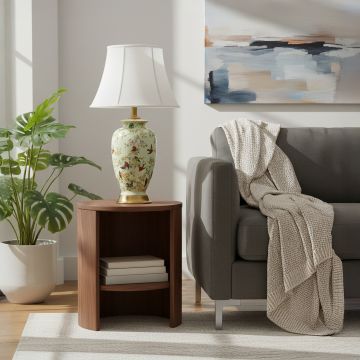 Green ceramic table lamp with hand painted bird floral artwork gold metal base and white fabric shade styled in living room.