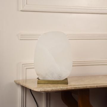 White marble table lamp unlit on white background featuring smooth white surface and gold base suited for modern decor themes.