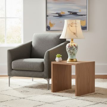 Mint green ceramic table lamp with hand painted bird and floral artwork gold metal base and fabric shade styled elegantly.