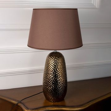 Bronze table lamp on white background with light off showcasing hammered surface and clean design lines.