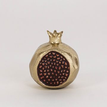 Miniature gold pomegranate with glossy finish and red seed detail displayed clearly on white background surface