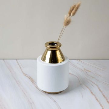 White ceramic vase with reflective gold top placed on a marble surface in a clean lifestyle setting highlighting its modern shape and elegant decorative appeal.