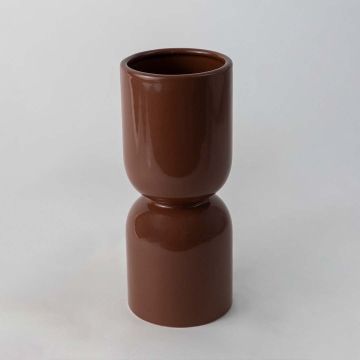 Modern brown ceramic vase with sleek glossy finish placed on white background ideal for table or shelf display.