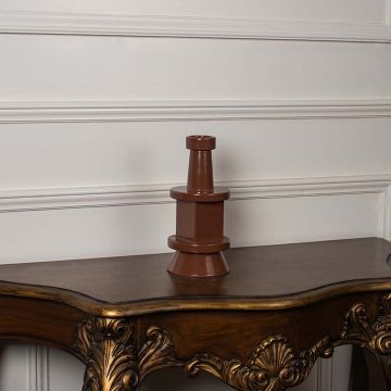 Contemporary brown vase set on a white background emphasizing its sculptural tiered form and polished surface for a bold modern decorative look.