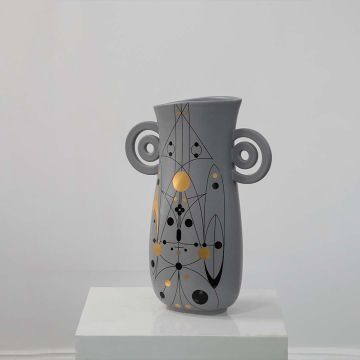 Grey ceramic vase with abstract gold and black detailing and loop handles displayed on a clean white background for modern decor styling.