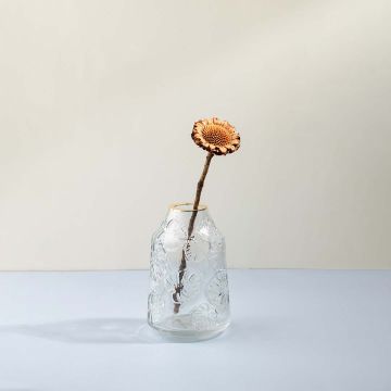 Elegant transparent glass flower vase with embossed design styled with dried flower on wooden table lifestyle image.