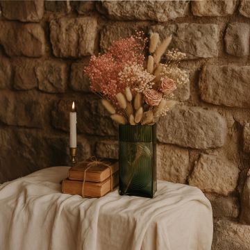Smoke brown ribbed rectangular glass vase with dried flowers styled beside candle and books on rustic table for artistic home setting.