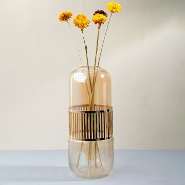Tall amber glass vase with gold striped detailing holding yellow flowers styled for modern home interior decor glass vase.