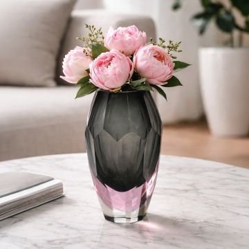 Grey and pink glass decorative vase with fresh flowers placed on marble table adding elegant charm to living room decor.