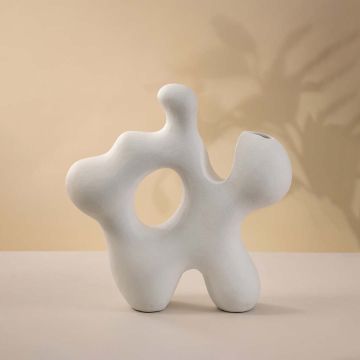 Contemporary white ceramic vase featuring artistic curves and creative modern sculptural style against white backdrop.
