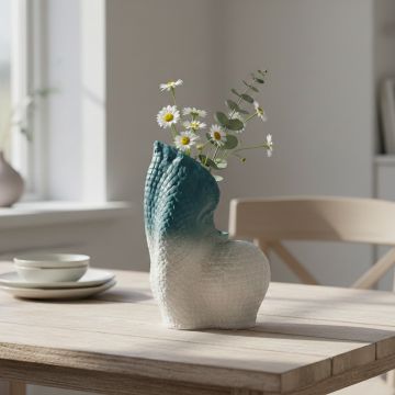 Blue and white ceramic abstract sculpture with textured finish styled on console table for modern living room decor.