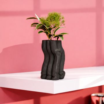 Black ceramic textured floor vase with sculpted organic design perfect for dried flower display in living room corner and modern home decor.
