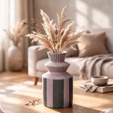 Multicolor ceramic decorative vase styled with dried stems on wooden table enhancing warm and modern home decor.