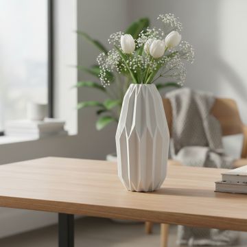 White ceramic flower vase with fresh blooms placed near window brightening modern living room decor.