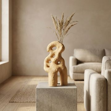 Beige ceramic abstract decorative sculpture displayed on console table creating warm and contemporary interior decor accent.