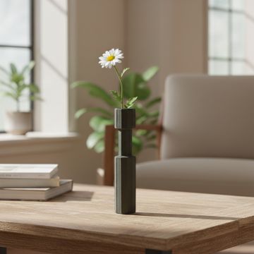 Dark green metal candle holder with floral stem placed on wooden table adding modern elegance to living room decor.