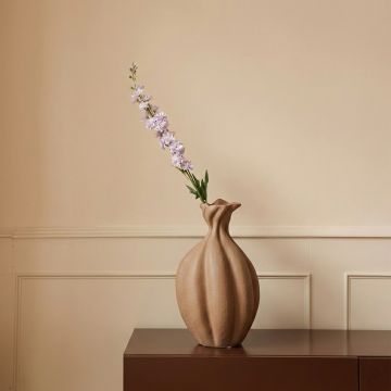Beige ceramic decorative vase with sculpted organic petal shape perfect for dried flower display on console table and modern home decor.