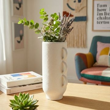 White ceramic decorative vase with triple handle design perfect for dried flower display on console table and modern home decor.
