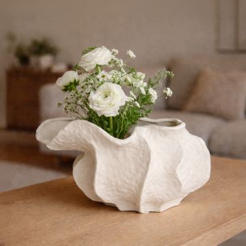 White ceramic abstract decorative bowl styled with fresh flowers enhancing soft and sophisticated home decor setting.