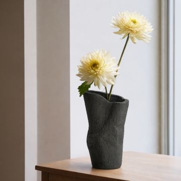 Black ceramic decorative floor vase with organic sculpted shape perfect for dried flower display in living room corner and modern home decor.