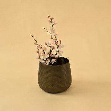 Brown metal planter decor styled in a warm modern room adding rustic elegance to living room tables and console accents.