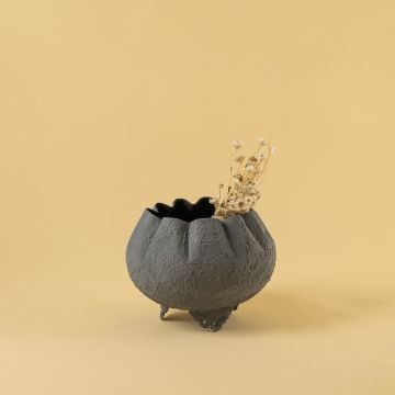 Grey metal scalloped bowl planter placed on a cosy tabletop adding a soft modern touch to warm contemporary interiors.