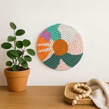 Colorful cotton woven wall plate decor in green orange pink and white shades displayed in a bright lifestyle setting for stylish modern home interiors.