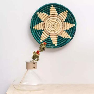 Natural bamboo wall plates in green beige tones styled on white wall enhancing minimal cozy living room aesthetics.