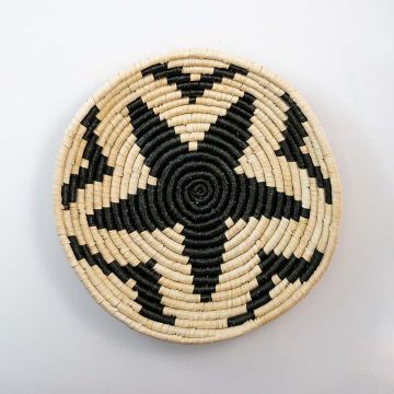 Handwoven basket wall plate on plain white background showing natural weaving texture.