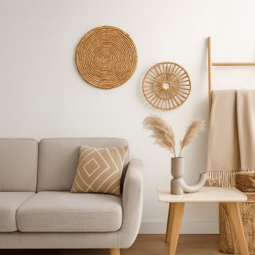 Handcrafted rattan wall plate displayed above a beige sofa with neutral tones adding rustic charm to modern interiors.