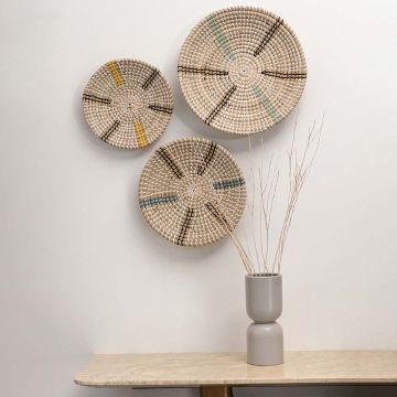 Large woven wall plate displayed in a minimalist living room above a marble console and neutral decor vase for cozy home styling.