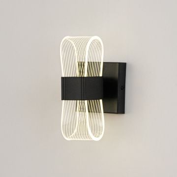Black wall light illuminated on a white background showing soft warm glow through curved acrylic.
