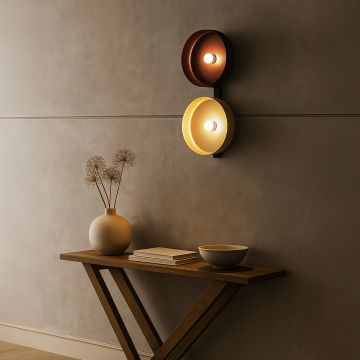 Bronze and gold wall light with modern black frame mounted above console table in minimalist beige interior.