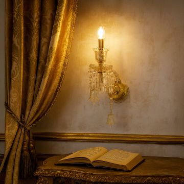 Double arm crystal wall light glowing in luxury room with golden sofa and ornate framed painting decor.