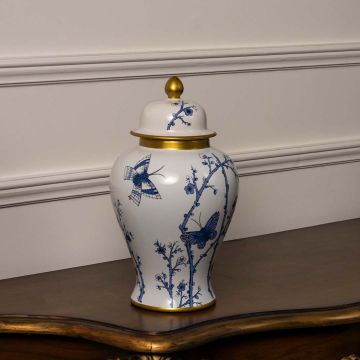 Elegant ceramic decor jar in white with blue flower and butterfly design and gold detailing for modern interiors.
