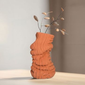 Terracotta sculptural floor vase styled in interior modern artistic ceramic decor statement piece for living room corner styling.