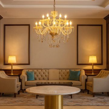 Golden crystal chandelier glowing warmly in luxurious living room with sofa lamps and elegant interior decor.